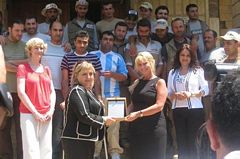 Rania Chidiac offering the trophy to MAG country program manager, Ms Bannike, on behalf of Cega UK and Mideast assistance